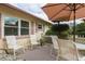 Relaxing patio with umbrella, chairs, and small table at 102 Stafford Dr, Palm Harbor, FL 34684