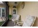Cozy screened porch with two chairs and a small table at 102 Stafford Dr, Palm Harbor, FL 34684
