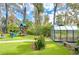 Landscaped backyard with playset and greenhouse at 105 Locust Dr, Brandon, FL 33511