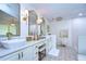 Elegant bathroom with double sinks, a soaking tub, and walk-in shower at 105 Locust Dr, Brandon, FL 33511