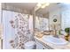 Charming bathroom with floral shower curtain and updated vanity at 105 Locust Dr, Brandon, FL 33511