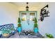 Inviting entryway with double doors, decorative plants, and a personalized metal sign at 105 Locust Dr, Brandon, FL 33511