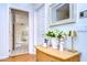 Light and bright hallway with wood floors, leading to a spacious bathroom at 105 Locust Dr, Brandon, FL 33511