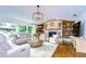 Spacious living room with a stone fireplace and large windows at 105 Locust Dr, Brandon, FL 33511