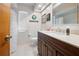 Clean bathroom with dark vanity, white toilet and tiled flooring at 1066 Larkin Rd, Spring Hill, FL 34608