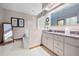 Main bathroom with double sinks, granite vanity, and a large walk-in shower at 1066 Larkin Rd, Spring Hill, FL 34608