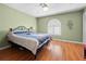 Bedroom with hardwood floors, a large window, and ceiling fan at 1066 Larkin Rd, Spring Hill, FL 34608