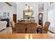 Elegant dining room with a large table, chandelier, and hardwood floors at 1066 Larkin Rd, Spring Hill, FL 34608