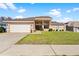 Single-story home with attached garage and well-manicured lawn at 1066 Larkin Rd, Spring Hill, FL 34608