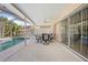 Covered patio with pool view, table and chairs at 1066 Larkin Rd, Spring Hill, FL 34608