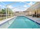 Relaxing screened-in pool with patio furniture at 1066 Larkin Rd, Spring Hill, FL 34608