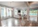 Open living room with hardwood floors, neutral color palette, and access to pool at 111 Philippe Grand Ct, Safety Harbor, FL 34695