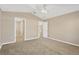 Primary bedroom with ceiling fan and access to en-suite bathroom at 12403 Streambed Dr, Riverview, FL 33579