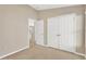 Bright bedroom featuring neutral walls, carpet flooring, and a double door closet at 12403 Streambed Dr, Riverview, FL 33579