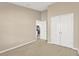 Spacious bedroom with neutral walls and carpeting, large closet at 12403 Streambed Dr, Riverview, FL 33579