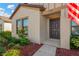 House exterior featuring a dark brown front door and manicured landscaping at 12403 Streambed Dr, Riverview, FL 33579