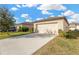 Attached single-car garage with a wide driveway at 12403 Streambed Dr, Riverview, FL 33579