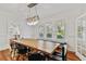 Elegant dining room with a long wooden table and chandelier at 1301 S Gunby Ave, Tampa, FL 33606