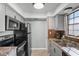 Galley kitchen with stainless steel appliances and granite countertops at 1320 Moreland Dr # 20, Clearwater, FL 33764