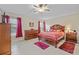 Spacious bedroom with ceiling fan and ensuite bathroom at 13987 Weddington Ter, Hudson, FL 34669