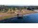 Aerial view showing a community boardwalk, dock, and lake access at 13987 Weddington Ter, Hudson, FL 34669