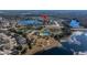 Aerial view of the community, highlighting its location near a lake and other amenities at 13987 Weddington Ter, Hudson, FL 34669