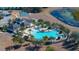 Aerial view of resort-style community pool with lounge chairs and surrounding landscaping at 13987 Weddington Ter, Hudson, FL 34669