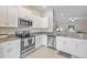Modern kitchen with stainless steel appliances and granite countertops at 13987 Weddington Ter, Hudson, FL 34669