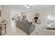 Open living room with gray sofas and view into kitchen at 13987 Weddington Ter, Hudson, FL 34669