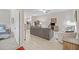 Open living area with gray sofas and view into bedroom at 13987 Weddington Ter, Hudson, FL 34669