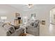 Spacious living room with gray sofas, a glass coffee table, and ceiling fan at 13987 Weddington Ter, Hudson, FL 34669