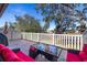 Relaxing patio with red furniture and view of pond at 13987 Weddington Ter, Hudson, FL 34669