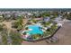 Community pool with plenty of lounge chairs and palm trees at 13987 Weddington Ter, Hudson, FL 34669
