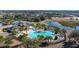 Community pool and clubhouse with surrounding landscaping at 13987 Weddington Ter, Hudson, FL 34669