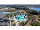 Community pool with surrounding lounge chairs and palm trees at 13987 Weddington Ter, Hudson, FL 34669