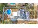 Aerial view showcasing home with pool and detached garage at 1447 Santa Anna Dr, Dunedin, FL 34698