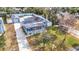 Aerial view of a cute blue house with a pool, detached garage, and yard at 1447 Santa Anna Dr, Dunedin, FL 34698
