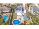 Aerial view showing home, pool, and detached shed at 1447 Santa Anna Dr, Dunedin, FL 34698