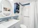 Bathroom with walk-in shower, white tile, and a white vanity at 1447 Santa Anna Dr, Dunedin, FL 34698