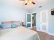Bedroom with a double bed, light blue walls, and access to bathroom at 1447 Santa Anna Dr, Dunedin, FL 34698