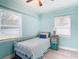 Bedroom with twin bed, light blue walls, and window blinds at 1447 Santa Anna Dr, Dunedin, FL 34698