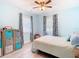 Bedroom with a double bed, light blue walls, and decorative curtains at 1447 Santa Anna Dr, Dunedin, FL 34698