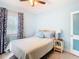 Bedroom with double bed, light blue walls, and patterned curtains at 1447 Santa Anna Dr, Dunedin, FL 34698