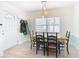 Bright dining area with wooden table, blue chairs, and hardwood floors at 1447 Santa Anna Dr, Dunedin, FL 34698
