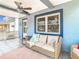 Relaxing front porch with wicker seating and ceiling fan at 1447 Santa Anna Dr, Dunedin, FL 34698