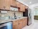 Updated kitchen featuring granite countertops, wood cabinets, and stainless steel appliances at 1447 Santa Anna Dr, Dunedin, FL 34698