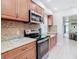 Modern kitchen with stainless steel appliances and granite countertops at 1447 Santa Anna Dr, Dunedin, FL 34698
