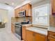 Modern kitchen with stainless steel appliances and granite countertops at 1447 Santa Anna Dr, Dunedin, FL 34698
