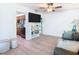 Living area with comfy couch, hardwood floors, and built-in shelving at 1447 Santa Anna Dr, Dunedin, FL 34698