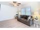 Bright living room with hardwood floors, comfy couch, and decorative accents at 1447 Santa Anna Dr, Dunedin, FL 34698